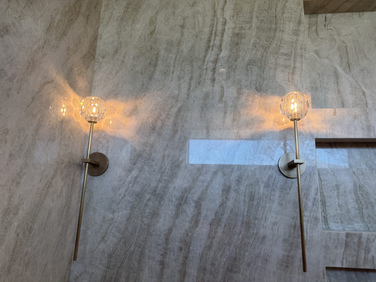 Matched wall sconces set on a quartzite feature wall.